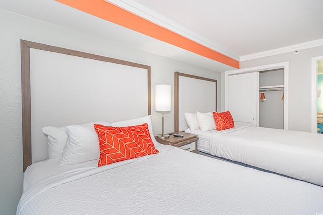 bedroom featuring ornamental molding and a closet