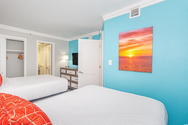 bedroom featuring a closet and ornamental molding