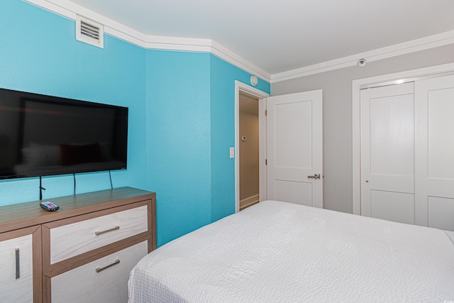 bedroom with ornamental molding and a closet