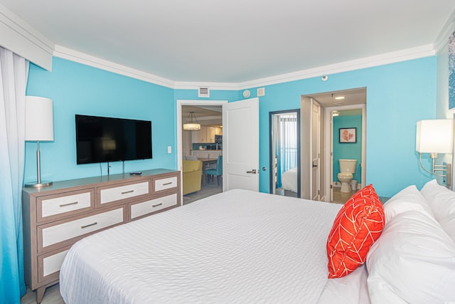 bedroom with ornamental molding and ensuite bathroom