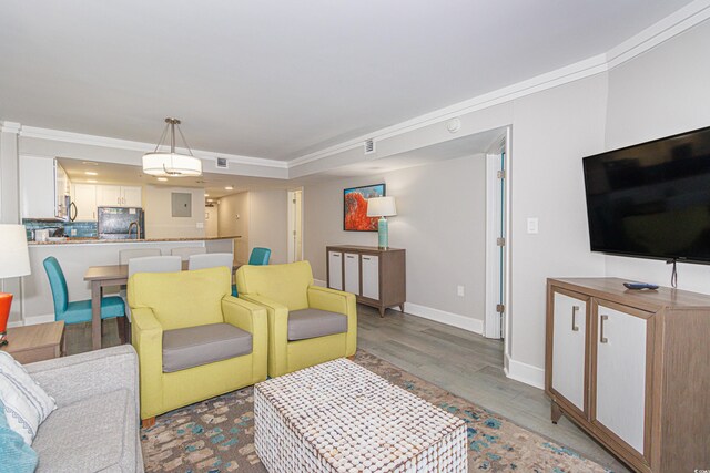 living room featuring crown molding and hardwood / wood-style floors