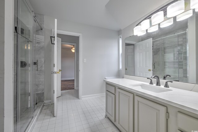 bathroom with tile patterned floors, vanity, and an enclosed shower