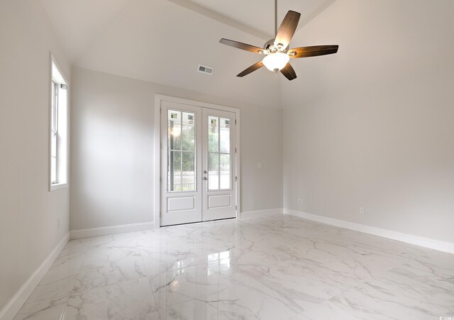 tiled spare room with ceiling fan and french doors