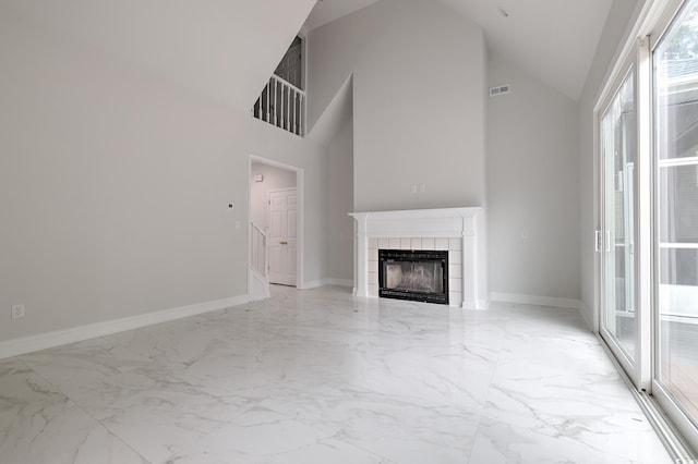 unfurnished living room with marble finish floor, baseboards, a fireplace, and visible vents