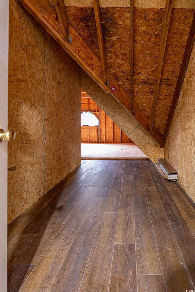 interior space with hardwood / wood-style flooring and vaulted ceiling