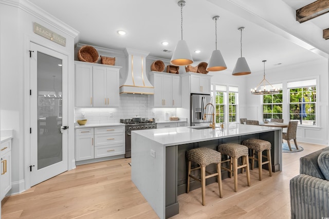 kitchen with white cabinetry, custom exhaust hood, stainless steel appliances, and a spacious island