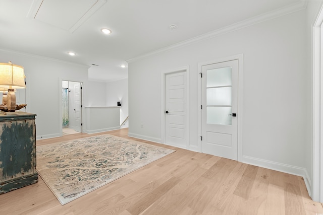 entrance foyer featuring ornamental molding and light wood-type flooring