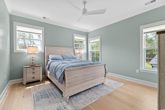 bedroom with crown molding, ceiling fan, and light wood-type flooring