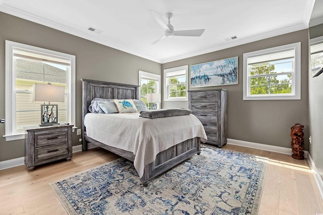 bedroom with ornamental molding, ceiling fan, and light wood-type flooring