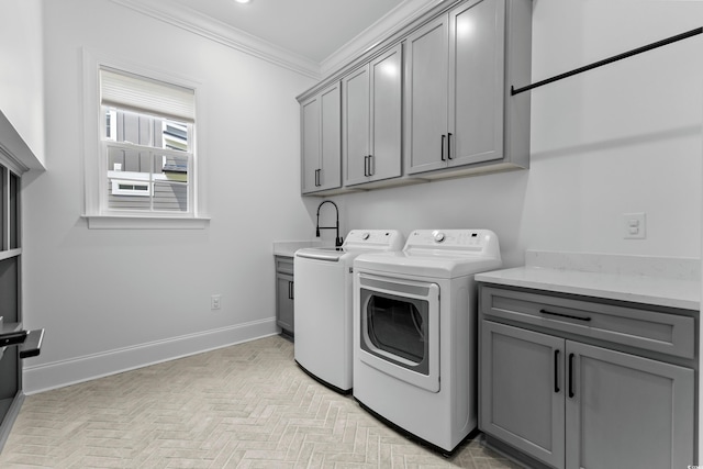 washroom with light parquet flooring, separate washer and dryer, sink, cabinets, and crown molding