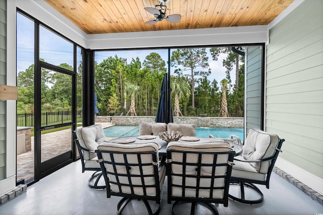 sunroom with wooden ceiling and ceiling fan