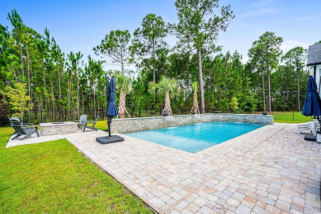 view of pool featuring a yard and a patio