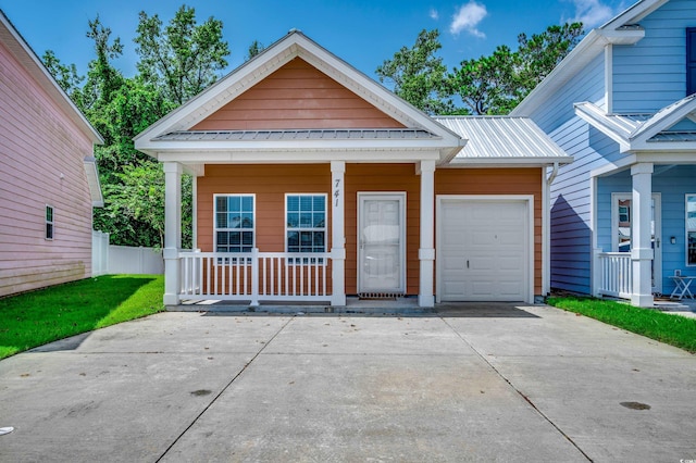 view of front of house featuring a garage and a porch