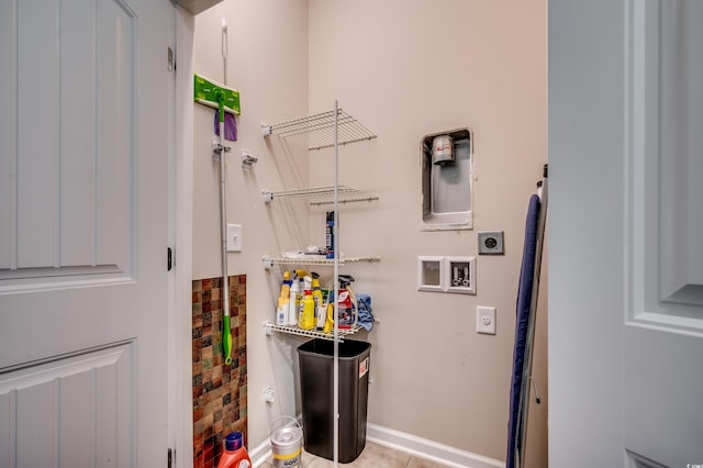 washroom featuring hookup for an electric dryer, washer hookup, and light tile patterned floors