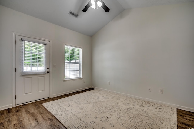 interior space featuring dark hardwood / wood-style flooring, vaulted ceiling, and ceiling fan