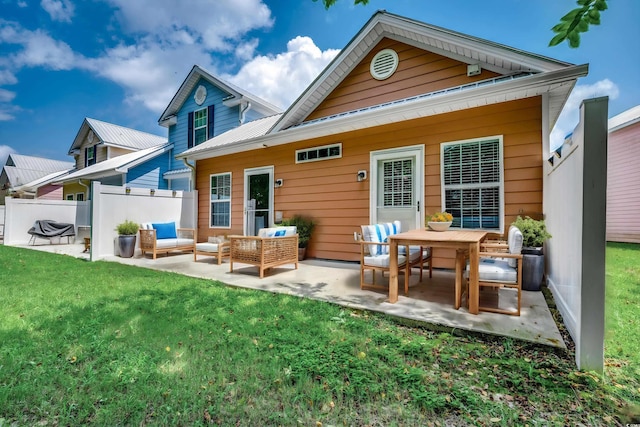 rear view of house with an outdoor living space, a patio, and a yard