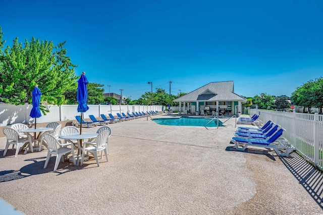 view of swimming pool with a patio