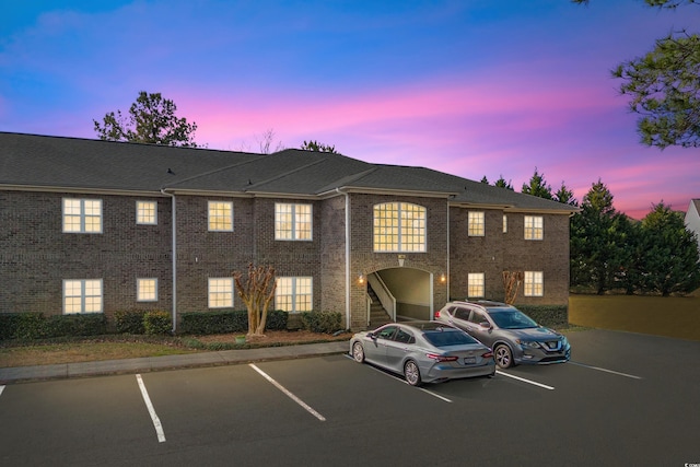 view of property featuring uncovered parking