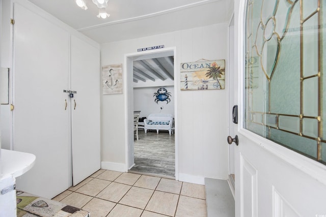 kitchen with white cabinetry, sink, beamed ceiling, white appliances, and light wood-type flooring