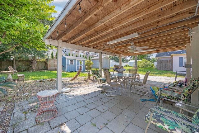 view of patio / terrace featuring ceiling fan and a storage shed