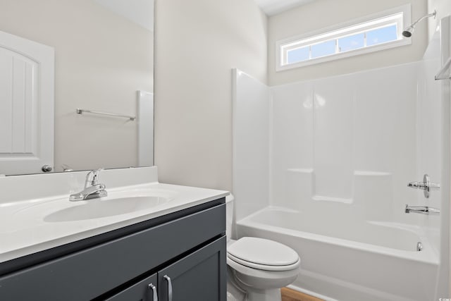 full bathroom featuring shower / bathing tub combination, vanity, and toilet