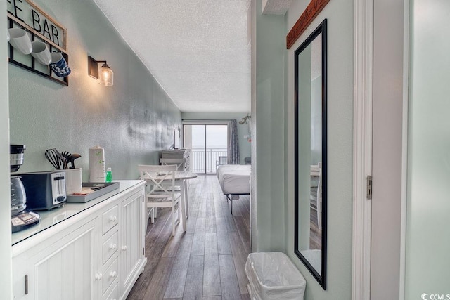 bathroom featuring wood-type flooring and a textured ceiling