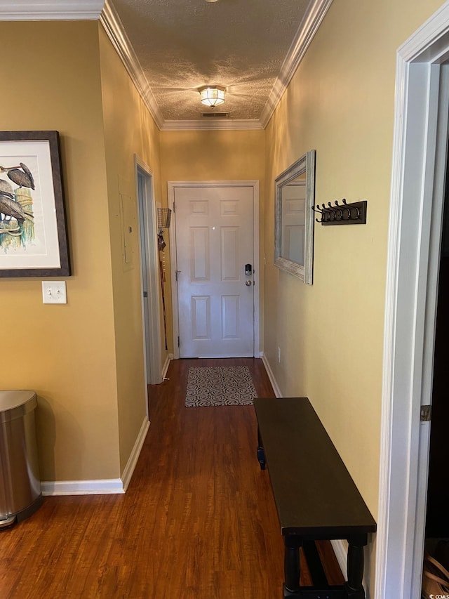 hall with dark wood-type flooring, crown molding, a textured ceiling, and baseboards