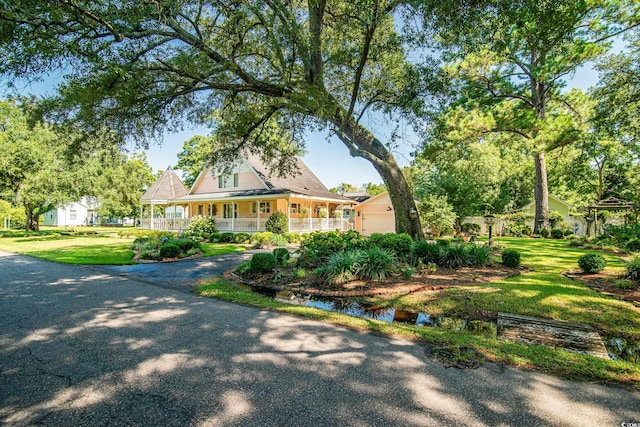 country-style home with covered porch and a front lawn