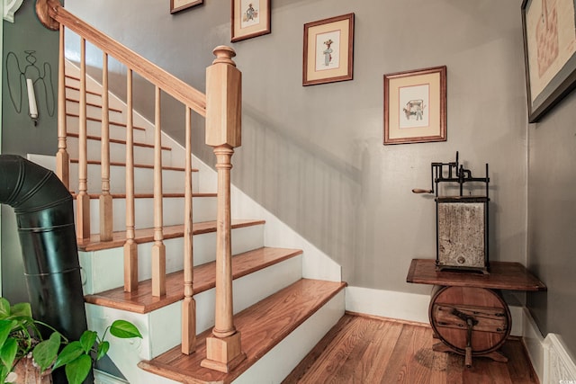 staircase featuring wood-type flooring