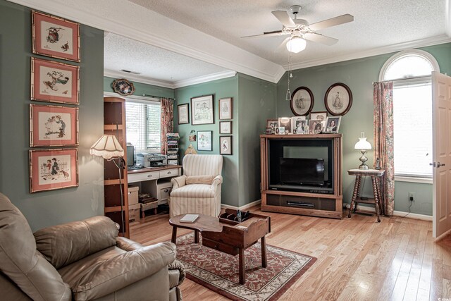 living room with light hardwood / wood-style flooring, a textured ceiling, and ceiling fan