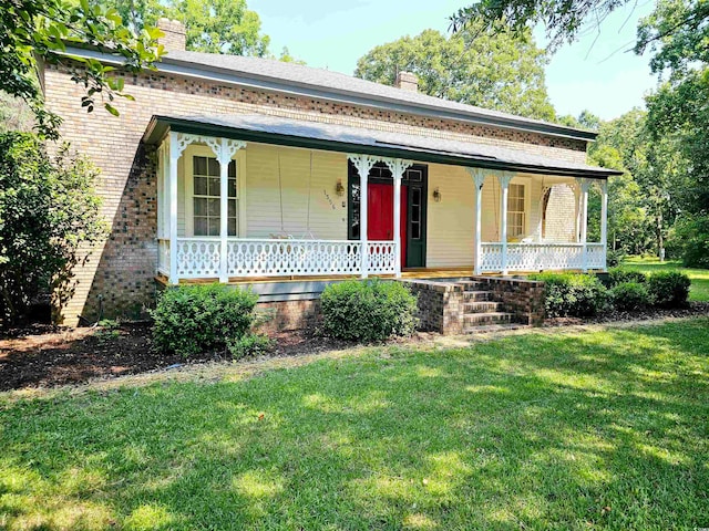 view of front of property with a front yard and a porch