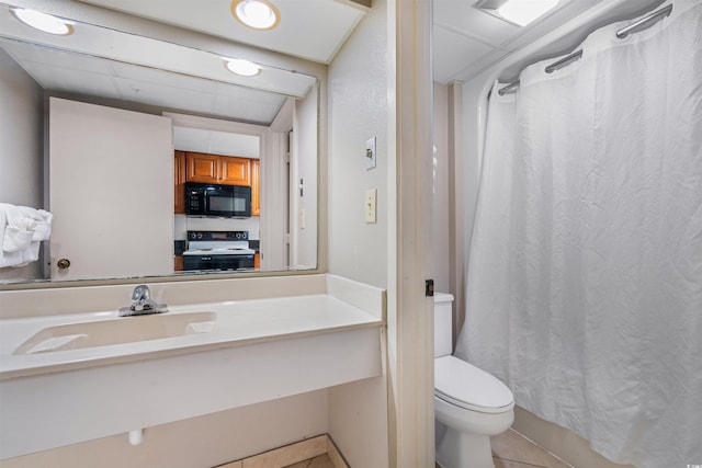 bathroom with vanity, toilet, and tile patterned flooring