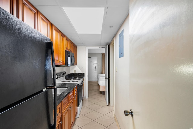 kitchen featuring black appliances, a drop ceiling, and light tile patterned flooring