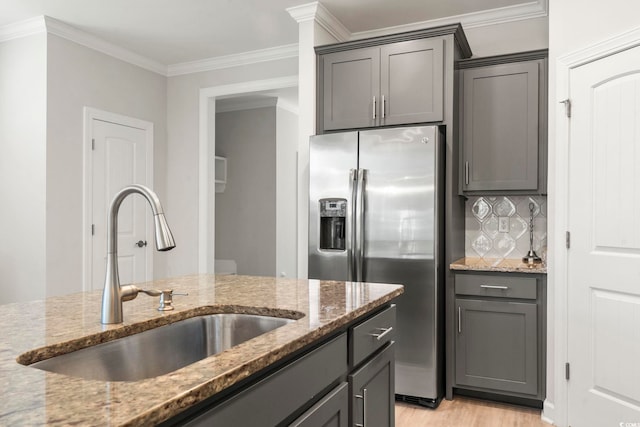 kitchen featuring stone countertops, sink, light hardwood / wood-style flooring, and ornamental molding