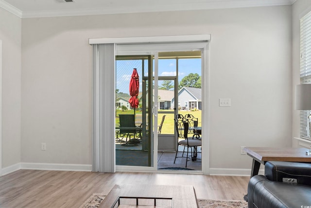 doorway featuring light hardwood / wood-style floors and ornamental molding