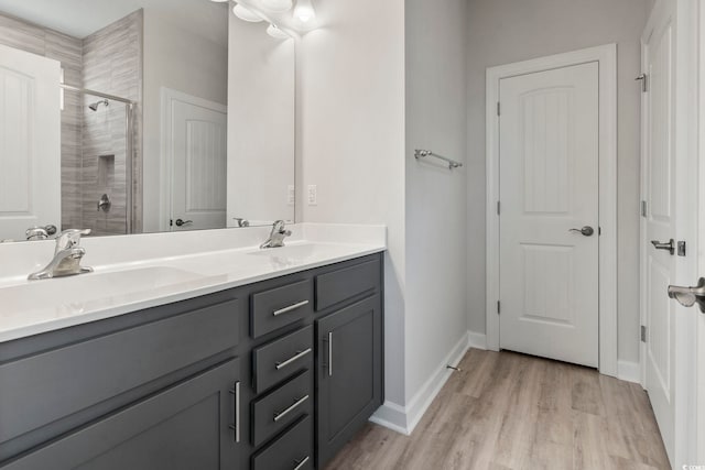 bathroom with wood-type flooring and double vanity