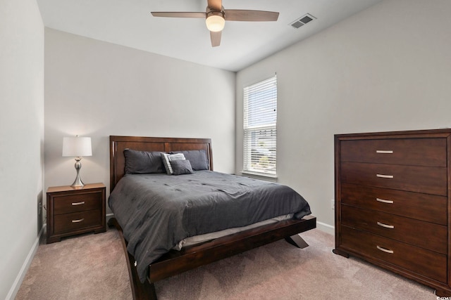 bedroom with ceiling fan and light carpet