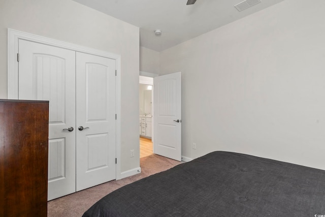 unfurnished bedroom featuring a closet, ceiling fan, and light carpet