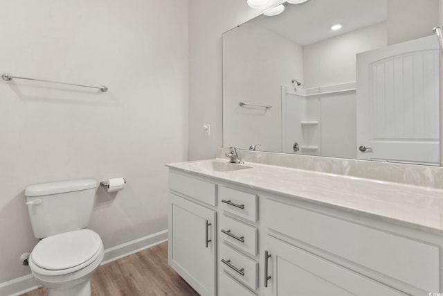 bathroom featuring hardwood / wood-style flooring, toilet, and vanity