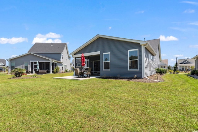 rear view of house with a patio and a yard