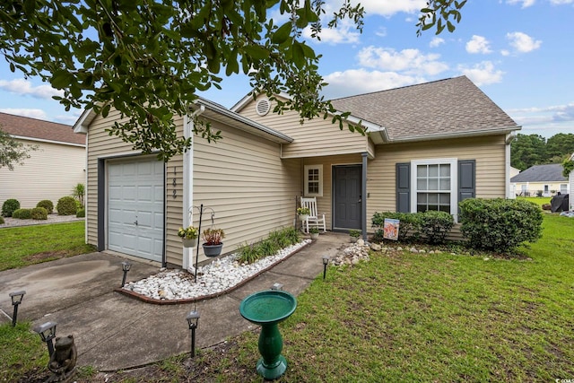 ranch-style house featuring a front yard and a garage