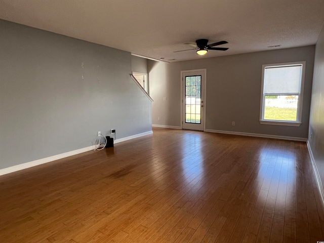 unfurnished room with ceiling fan, a textured ceiling, and hardwood / wood-style floors