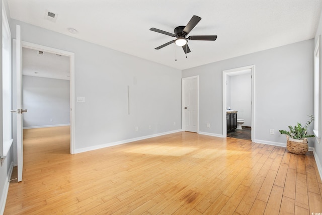 interior space with light wood finished floors, a ceiling fan, and baseboards