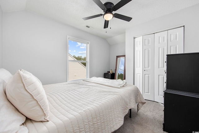 carpeted bedroom with ceiling fan, a textured ceiling, and lofted ceiling