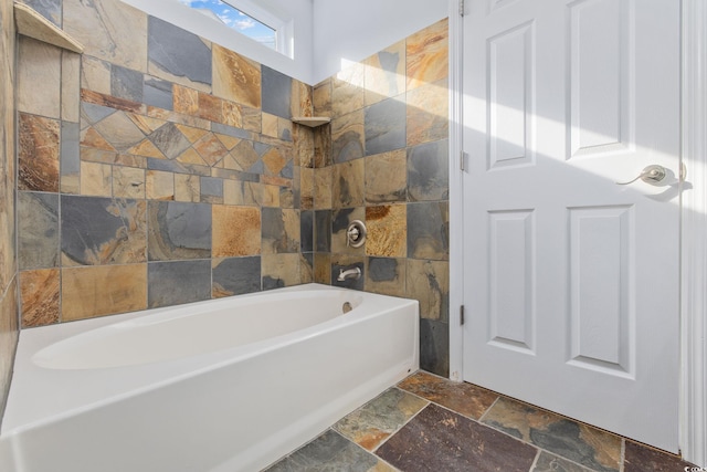 full bath featuring shower / tub combination and stone tile flooring