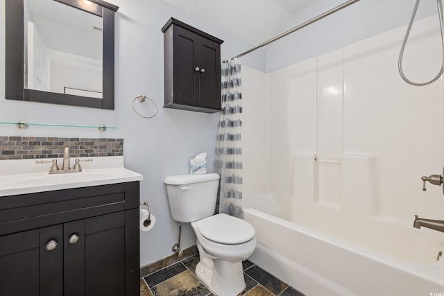 bathroom with decorative backsplash, toilet, shower / bath combo with shower curtain, stone tile flooring, and vanity