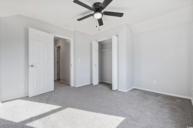 unfurnished bedroom with carpet floors, a closet, a ceiling fan, and baseboards