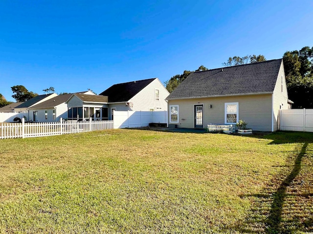 back of house with a yard