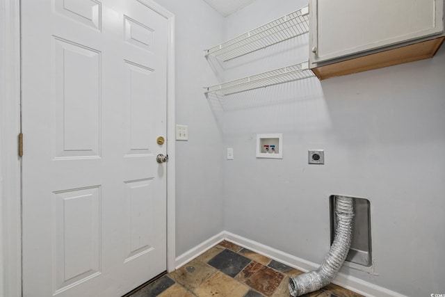 clothes washing area featuring baseboards, stone tile floors, cabinet space, and electric dryer hookup