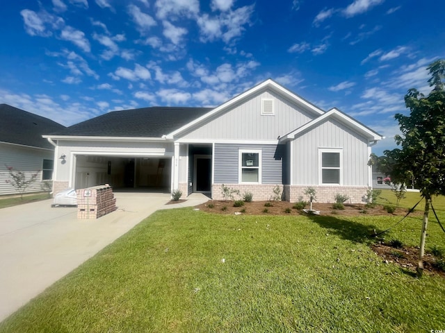 view of front of property featuring a garage and a front lawn